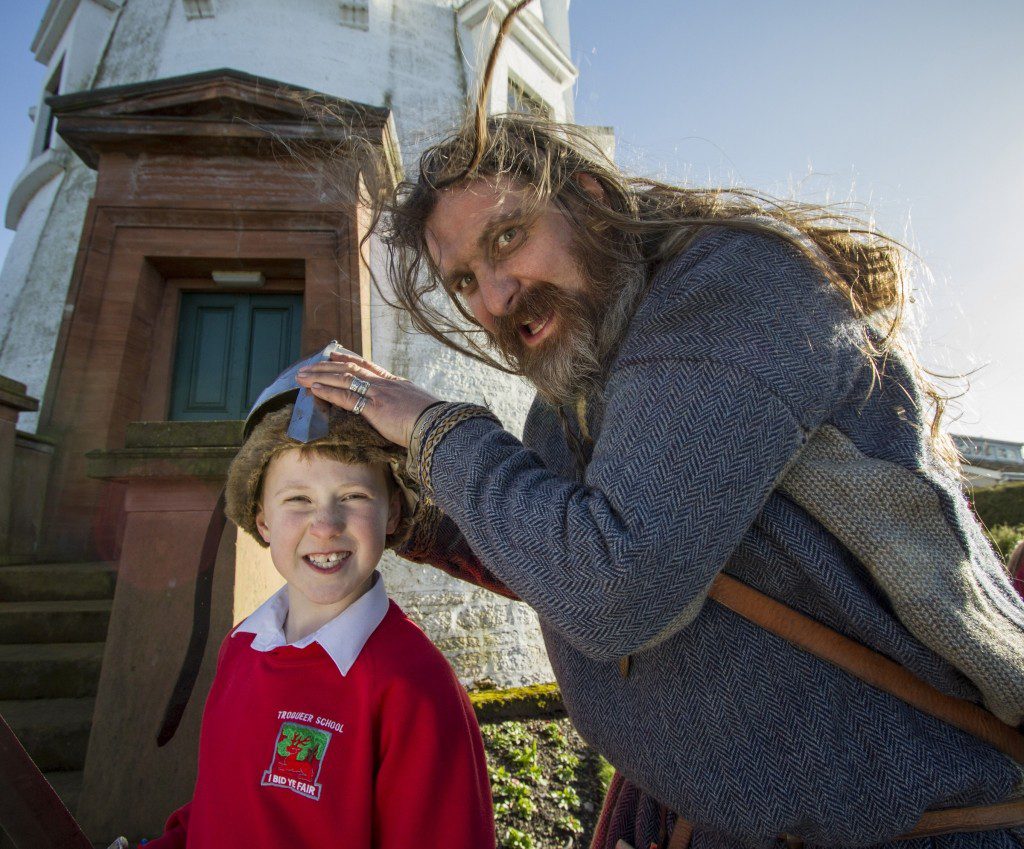 Viking re-enactor Simon Lidwell with a pupil from Troqueer primary school.