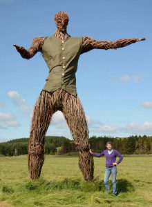Jennie Camm, Festival Director with the Gatekeeper wickerman in his new waistcoat
