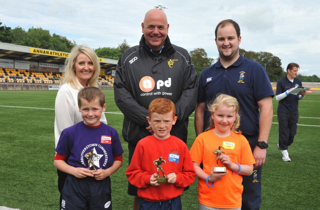 Active Games Festival 2015 – Rugby Presentation Back Row (L-R) Ali Cowan, Supply Chain Manager, Magnox Limited Gary Coupland, Annan Rugby Club Cammy Little, Moffat Rugby Club Front Row (L-R) Rugby - Player of the Day - Murray Ker, Cummertrees Primary School Rugby – Endeavour Award – Kris Byers, Kirkpatrick Fleming Primary School Rugby – Sportsmanship Award – Kara Waitt – Canonbie Primary School