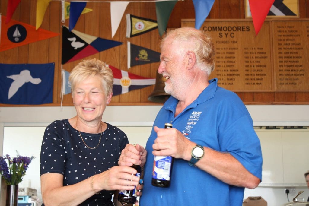 Steve Gaughan awarded the last finisher's “Fleet Prop” crew's beers but Liz Train doesn’t seem to want to let go! (Photo: Lindsay Tosh)